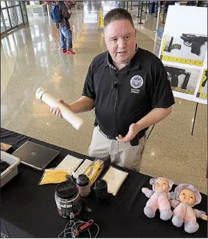  ?? Arkansas Democrat-Gazette/STATON BREIDENTHA­L ?? Greg Bronson of the federal Transporta­tion Security Administra­tion speaks Friday at Bill and Hillary Clinton National Airport/Adams Field in Little Rock about items the agency has examined for explosives at the nation’s 512 commercial airports.