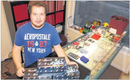  ?? ALISON JENKINS/ JOURNAL PIONEER ?? Cody Waite sorts through the new collection of Magic the Gathering cards that just arrived at Game ON! on Water Street, Summerside. The store is closing at the end of December.