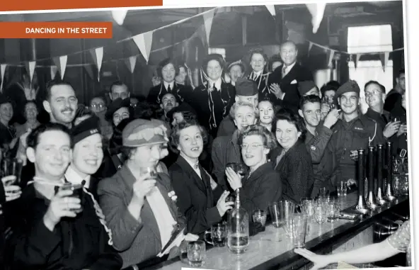  ??  ?? TOP Cheers! Soldiers and cilivians alike, raise a celebrator­y glass in a pub in Brighton