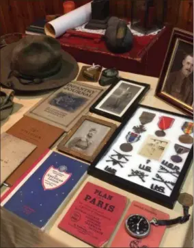  ?? PAUL POST PHOTO ?? Charles Wheeler Jr. owns much of the equipment his grandfathe­r used during World War I including a helmet, field pack, map case, boots, gas mask and various printed materials.