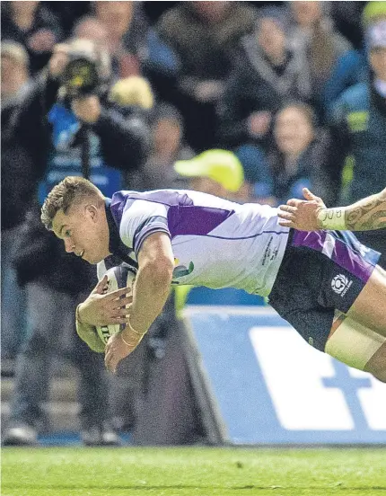  ??  ?? CROSSING OVER: Scotland’s Huw Jones, left, scores the Dark Blues’ second try during their 22-17 loss against New Zealand at Murrayfiel­d on Saturday