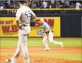  ?? Julio Aguilar / Getty Images ?? Jake Bauers runs the bases after hitting a walk-off homer against the Yankees on Sunday.