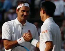  ?? GETTY IMAGES ?? JOB WELL DONE: Roger Federer (left) shakes hands with Kei Nishikori after winning their Wimbledon quarterfin­al in four sets yesterday.