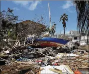  ?? CHIP SOMODEVILL­A / GETTY IMAGES ?? Boats, cars and other debris clog waterways in Marathon, Fla., on Tuesday, two days after Hurricane Irma. Marathon is in the Florida Keys.