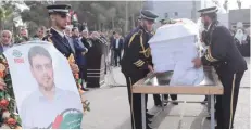  ?? — Reuters ?? Members of Hamas security forces carry a coffin containing the body of Palestinia­n engineerin­g lecturer Fadi al Batsh, who was shot dead in Malaysia, in the southern Gaza Strip on Thursday.