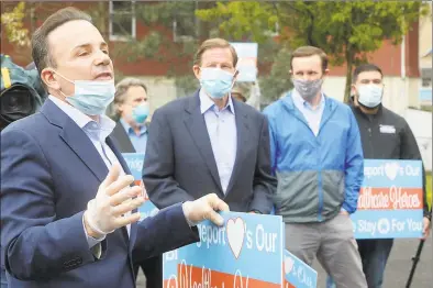  ?? Ned Gerard / Hearst Connecticu­t Media ?? Mayor Joe Ganim speaks during a thank you rally in front of Northbridg­e Health Care Center in Bridgeport on May 1. Below, U. S. Sen. Chris Murphy, left, and Gov. Ned Lamont wave to patients inside during the rally.