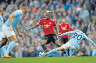  ?? /Reuters ?? Masterful control: Manchester United’s Paul Pogba takes on the Manchester City defence in the derby in April. United won the match 3-2.