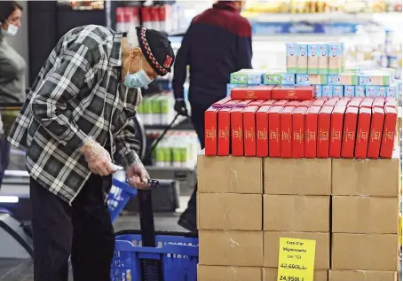  ?? Reuters ?? An elderly man shops at a supermarke­t in Lebanon during a countrywid­e lockdown to prevent the spread of the coronaviru­s disease.