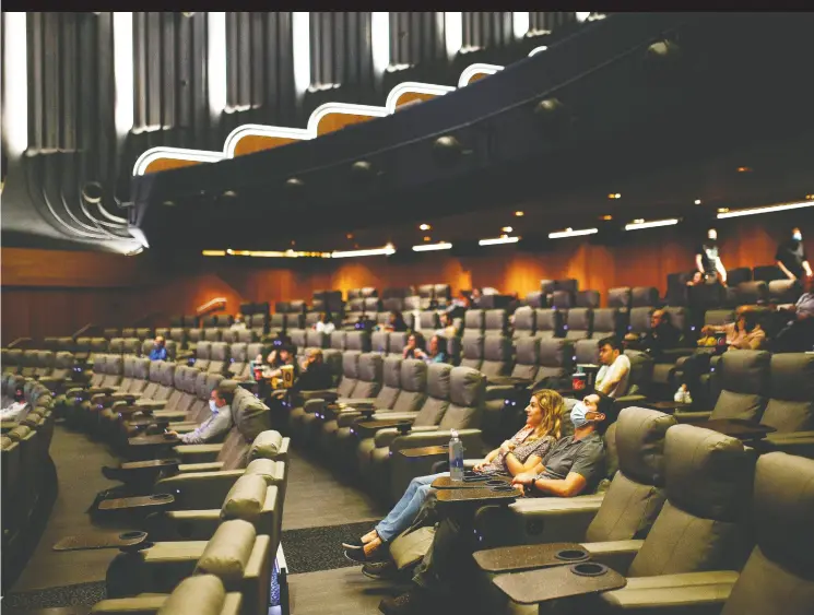  ?? Henry Nichols / REUTERS ?? People take their seats inside the Odeon Luxe Leicester Square cinema in London on the opening day of the film Tenet — one of the first major movies to be released in theatres
since the coronaviru­s shutdown. Movie distributo­rs have become protective of box- office numbers as secrecy has become the norm in pop culture, Sonny Bunch writes.