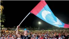  ??  ?? Supporters of Mahathir Mohamad celebrate the Opposition's victory. Reuters