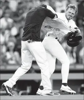  ?? Alex Gallardo Associated Press ?? THE DODGERS’ Gavin Lux, right, playfully strips off Cody Bellinger’s jersey after Bellinger’s walk-off home run against the Cubs.