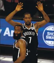  ?? ADAM HUNGER — THE ASSOCIATED PRESS ?? Brooklyn’s Kevin Durant (7) celebrates with James Harden during the second half of their victory against Milwaukee.