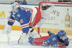  ?? DAVID BEBEE
THE KITCHENER-WATERLOO RECORD ?? Kitchener Rangers goalie Mario Culina, shown jumping over a sliding Connor Hall, is a leading candidate to be the Ontario Hockey League’s comeback player of the year.