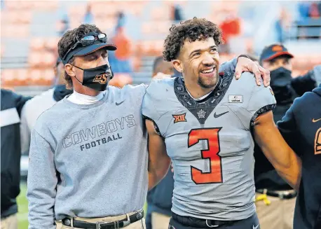  ??  ?? Oklahoma State head coach Mike Gundy sings the alma mater with quarterbac­k Spencer Sanders (3) after beating Iowa State 24-21 at Boone Pickens Stadium last Saturday. [SARAH PHIPPS PHOTOS/ THE OKLAHOMAN]