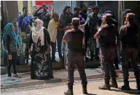  ?? AFP ?? Security forces stand outside Maldivian Democratic Party office as they barricade it in the capital Male. —