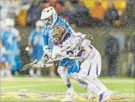  ?? PHOTOS BY MIKE GROLL — THE ASSOCIATED PRESS FILE ?? UAlbany TD Ierlan in action in the face-off circle during the Danes NCAA contest against North Carolina.