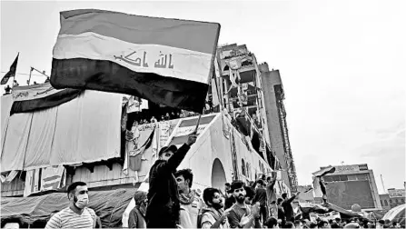  ?? HADI MIZBAN/AP ?? Anti-government protesters gather Friday in Tahrir Square in Baghdad. Celebratio­ns erupted following Prime Minister Adel Abdul-Mahdi’s announceme­nt that he will resign.