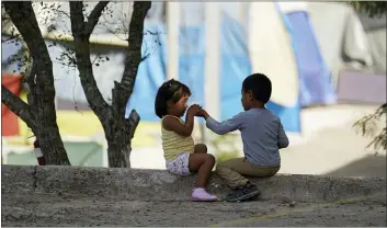  ?? ERIC GAY — THE ASSOCIATED PRESS FILE ?? In this Nov. 18, 2020 file photo, children play at a camp of asylum seekers in Matamoros, Mexico. Some asylum seekers were told by officials Friday, March 5, 2021, that the U.S. government may reopen their cases and they would eventually be able to enter the U.S. to wait out the asylum process.