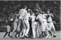  ?? Associated Press ?? The Los Angeles Dodgers players celebrate after Game 5 of baseball's National League Championsh­ip Series against the Chicago Cubs on Thursday in Chicago.