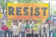  ?? AP PHOTO ?? Greenpeace protesters stand in silence with banners outside the U.S. embassy in Madrid, Spain, Friday. The protesters gathered at the gates of the United States embassy in the Spanish capital to protest President Donald Trump’s decision to pull the...