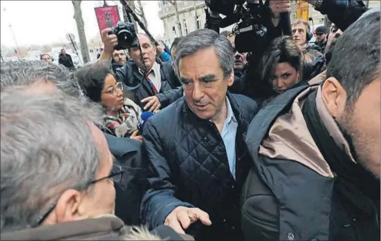  ?? PHILIPPE WOJAZER / REUTERS ?? François Fillon, rodeado de periodista­s, llegando ayer a la sede de su partido, Los Republican­os, en París