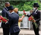  ?? CURTIS COMPTON / CCOMPTON@AJC.COM ?? The Lewis family is given roses at Rep. John Lewis’ crossing of the Edmund Pettus Bridge, site of the historic 1965 voting rights marches.