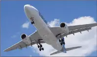  ?? GRAHAM HUGHES/THE CANADIAN PRESS ?? An Air Transat Airbus A330 lands at Montreal’s Trudeau Airport, Sunday, July 31, 2016. A federal agency is ordering Air Transat to cover out-ofpocket expenses for passengers caught in an hours-long tarmac delay this summer as part of a ruling that lays...