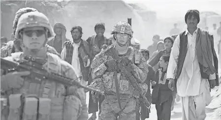  ?? 2014 PHOTO BY SCOTT OLSON/ GETTY IMAGES ?? Staff Sgt. Thomas Taylor, left, and Pfc. Zachary Brome with the U. S. Army’s 4th squadron 2d Cavalry Regiment patrol with soldiers from the Afghan National Army Kandahar, Afghanista­n.