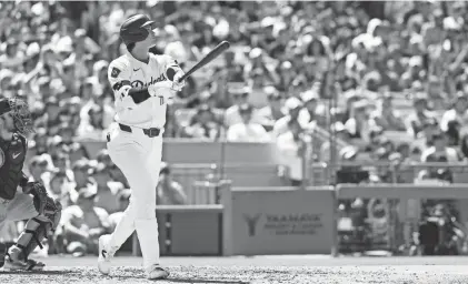  ?? KIYOSHI MIO/USA TODAY SPORTS ?? Dodgers designated hitter Shohei Ohtani follows through on a home run against the Braves on Sunday in Los Angeles. Ohtani hit two home runs on the Dodgers’ 5-1 victory.