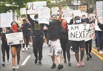  ?? Brian A. Pounds / Hearst Connecticu­t Media ?? Protesters chant slogans while marching down the Post Road during an organized Black Lives Matter police brutality protest in Fairfield on Tuesday.