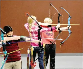  ??  ?? Lincoln students (from left): Eduardo Ruvalcaba, 10; Madilyn Anderson, 11; and Cooper Geng, 11; shoot arrows at targets in Lincoln’s Elementary gym during a National Archery in Schools Program event held Saturday, Jan. 16.