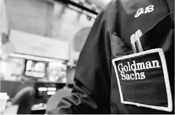 ??  ?? A trader works at the Goldman Sachs stall on the floor of the New York Stock Exchange, New York, US. A slump in Goldman Sachs’s longdomina­nt trading business has sharpened questions about the Wall Street kingpin’s strategy as technologi­cal change...