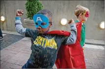  ??  ?? Wyatt Persons shows off his superhero costume Saturday before the start of the Superhero Science Night at the Children’s Museum of Atlanta.