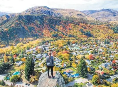  ??  ?? Debbie Pettinger’s daughter Jade surveys the riot of changing colours in Arrowtown. Pettinger’s image of the Central Otago town won an Otago Daily Times’ “Awesome autumn” photograph­ic competitio­n.