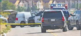  ?? AP/Midland Reporter-Telegram/TIM FISCHER ?? Authoritie­s surround a U.S. Postal Service vehicle Saturday in Odessa, Texas, that was stolen by the gunman who began shooting people at random as he drove though Odessa and nearby Midland.