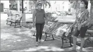  ??  ?? Mujeres caminan en el parque de Tizimín, con bancas encintadas