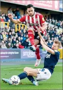  ?? ?? JUMP TO IT: George Baldock battles with Millwall’s Billy Mitchell