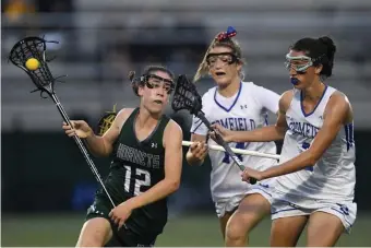  ??  ?? LOOKING AHEAD: Manchester Essex’s Lily Athanas, left, carries the ball against Bromfield during the Div. 2 state semifinals in 2019.