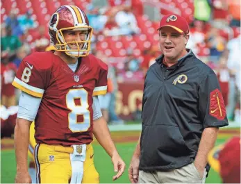  ?? BRAD MILLS, USA TODAY SPORTS ?? Coach Jay Gruden, right, doesn’t want Kirk Cousins to put too much pressure on himself.