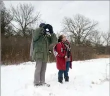  ?? DAVID BEBEE, RECORD STAFF ?? Dawn Miles and Peter Coo scan the skies during the Kitchener Christmas Bird Count Saturday.
