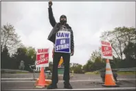  ?? The Associated Press ?? STRIKE: Ryan Piper with the United Auto Workers continues to picket after news of a tentative contract agreement with General Motors, in Langhorne, Pa., on Wednesday.