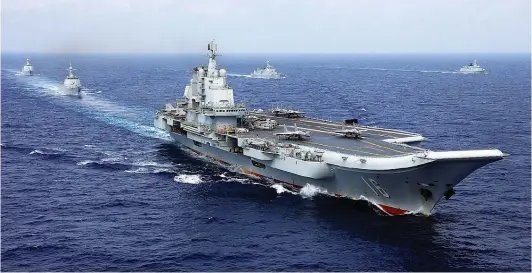  ?? PHOTOGRAPH: eng.chinamil.com.cn / Zhang Lei ?? Chinese Aircraft Carrier Liaoning (Hull 16), several guided-missile destroyers and frigate out in the South China Sea