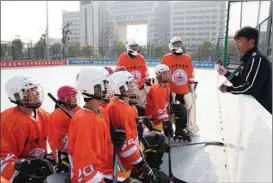  ?? XINHUA ?? Youngsters play ice hockey at a rink in Mingguang, Anhui province. The venue opened in 2019, and now hosts a number of different agegroup teams from Mingguang High School. Despite its temperate climate, the province is witnessing a surge of interest in winter sports.