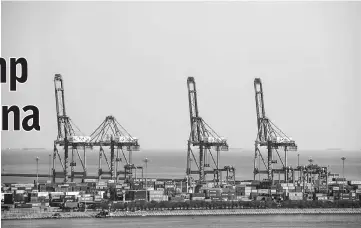  ??  ?? Gantry cranes stand in the port facility in Qinhuangda­o, China, on Oct 28. — WP-Bloomberg photo