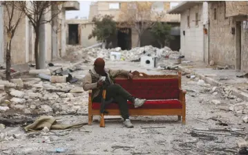  ?? (Reuters) ?? A FIGHTER with the Turkey-backed Free Syrian Army sits amid rubble in the eastern suburbs of al-Bab earlier this week.