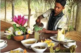  ??  ?? AUTHENTIC: Preparing food at The Mudhouse. Right: A Sri Lankan leopard