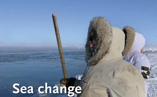  ??  ?? Hunters Peter Kattuk (left) and Daniel Qavvik, part of a research collective recording environmen­tal changes on Hudson Bay, search for belugas near Sanikiluaq, Nunavut.