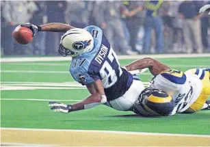  ?? [PHOTOS BY USA TODAY SPORTS] ?? In this Jan. 30, 2000, photo, Rams linebacker Mike Jones hangs on as Titans receiver Kevin Dyson reaches for the end zone on the final play of Super Bowl XXXIV in Atlanta.