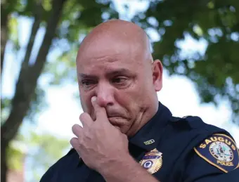  ??  ?? SHAKEN: Saugus Assistant Police Chief Ronald Giorgetti discusses the condition of the three injured police officers at the scene of Thursday’s stabbing. The injuries were not considered life-threatenin­g.