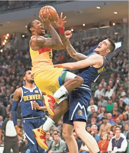  ?? JEFF HANISCH/USA TODAY ?? Bucks guard Eric Bledsoe shoots over Nuggets forward Juan Hernangome­z in the first quarter Monday night. Bledsoe finished with 23 points.